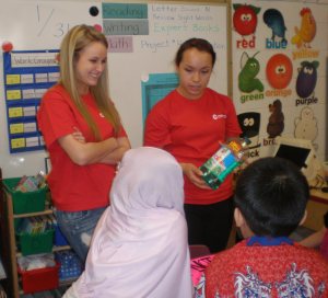 Katie and Nicole from the Como Park Future Educators Club talk with kids about safe substances versus poisons in the home. (Photo credit: Lisa Joyslin/American Red Cross)