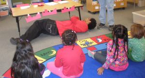 Dominic, a Como Park High School student, demonstrates how to stop, drop and roll. (Photo credit: Lisa Joyslin/American Red Cross)