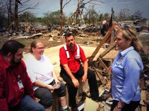 Kimberly Graham lost her home in Moore, Oklahoma. Here, she sits, holding onto a personal picture she found near her home. (Photo courtesy of Red CrossOKC)