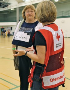 Volunteer evacuee Maggie Friend talks to a Red Cross volunteer about her mental health. 