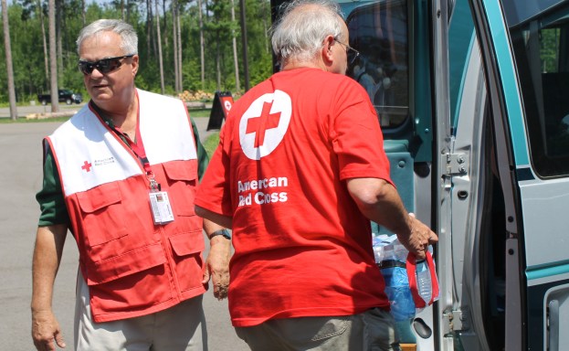 The Red Cross provided water, ice and relief supplies at the relief station. Like many Red Cross volunteers, Gary Larson and Ken Vertin spent the day loading cases of water into vehicles.