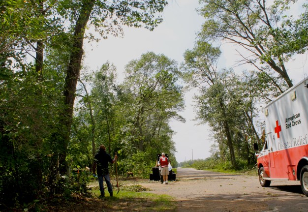 Red Cross volunteer Rick Campion walked through an storm affected neighborhood in the Brainerd Lakes area on July 15, 2015. Photo credit: Vivian Engen/American Red Cross.