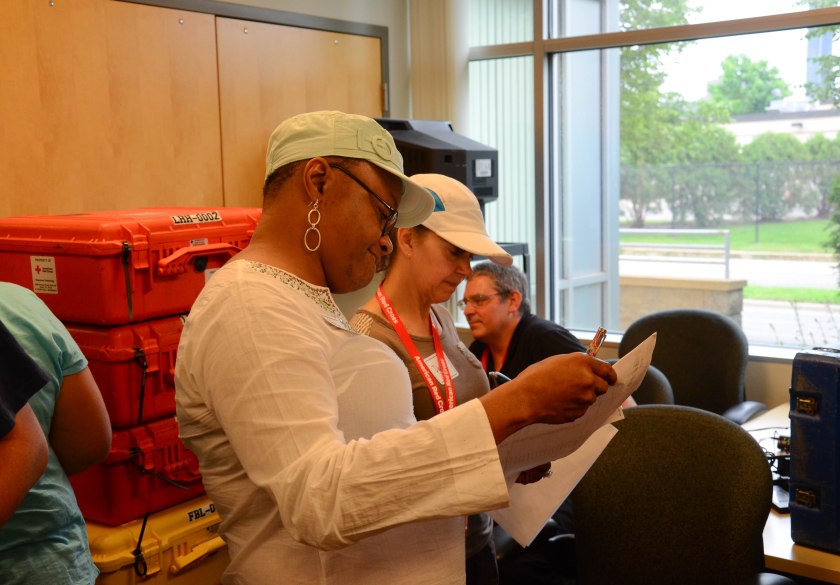 American Red Cross trainees, Debbie Johnson and Phyllis Wiggins, checking supplies for disaster services technology operations during a practice run