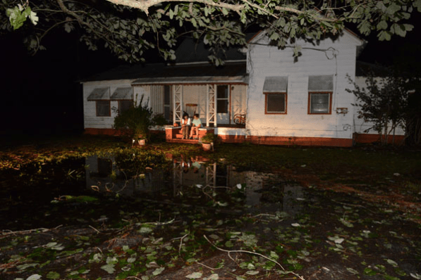 The storm hit in the early morning, just after midnight, says Stephanie Hughes on the porch of her home while speaking with a Red Cross relief worker in Pembroke, Georgia. They were very scared especially, she says, when trees started to come down and water started rising around the house, which has been in her family for generations. October, 8, 2016. Photo credit: Daniel Cima/American Red Cross