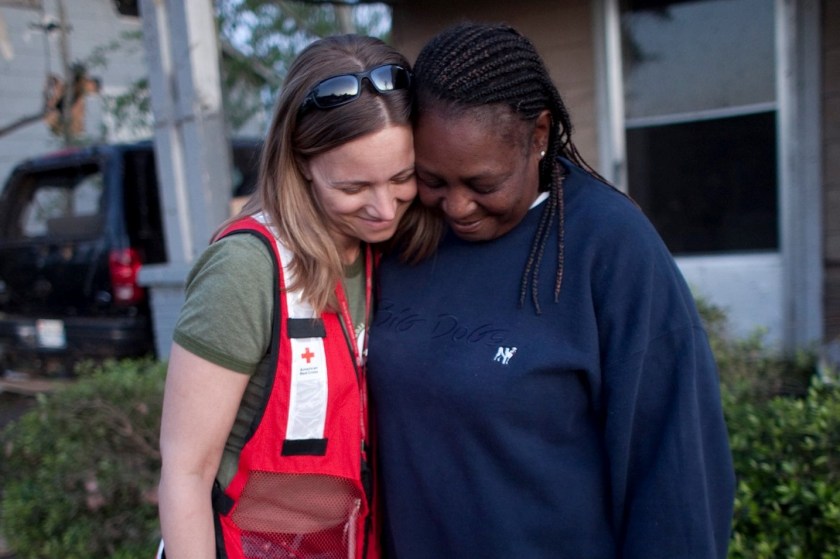 In 2011, following a devastating tornado in Tuscaloosa, Alabama, Georgette Evans, who walked miles to find medical services and safe shelter following the devastating tornado, visits with to Lynette Nyman in Alberta City neighborhood. Photo credit: Dennis Drenner/American Red Cross